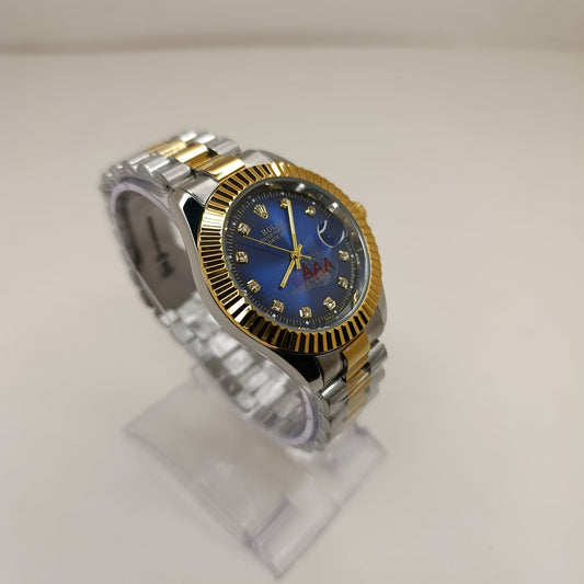 Two-tone watch with blue face on a clear stand against a white background